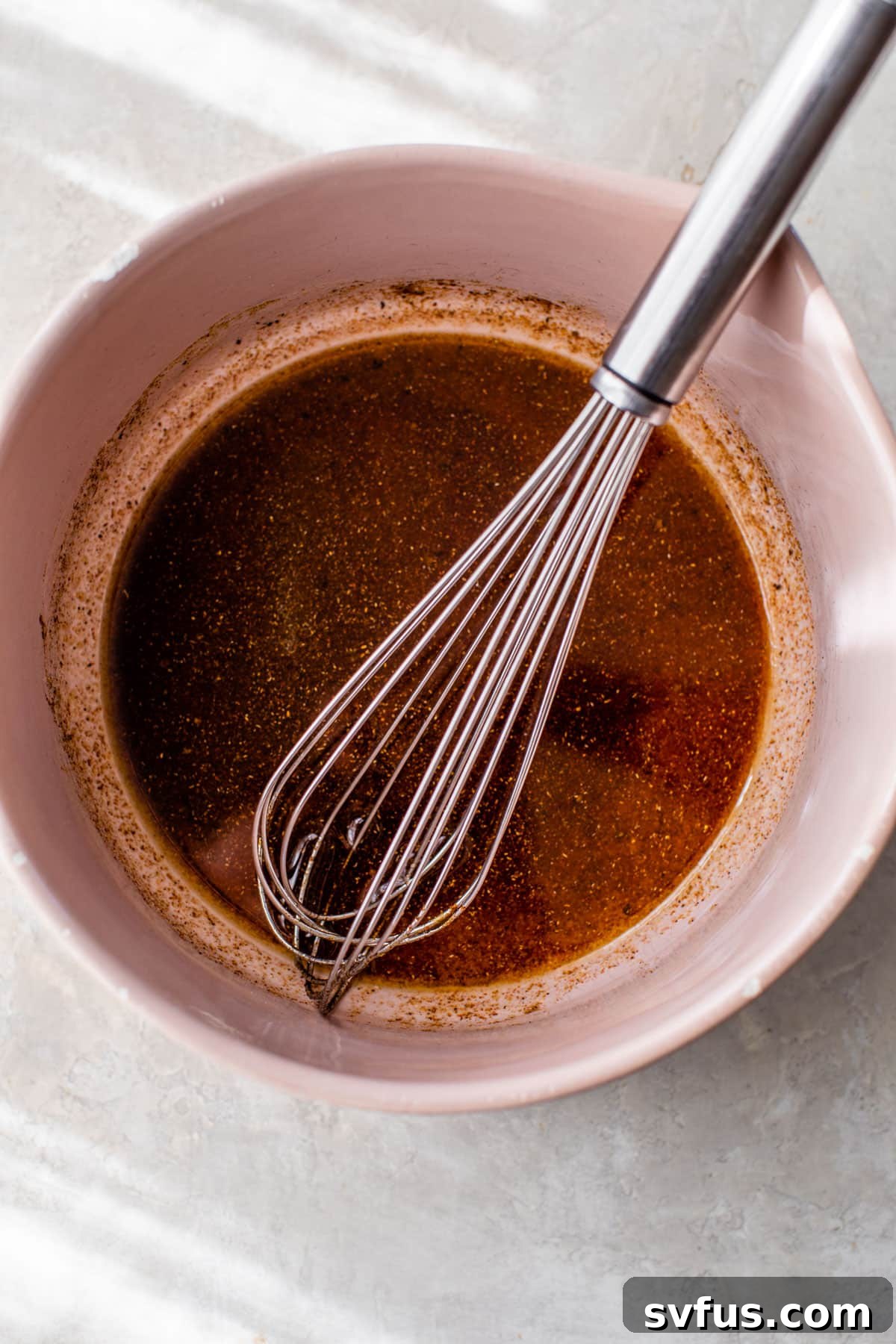 Olive oil and a blend of smoky, spicy seasonings whisked together in a bowl