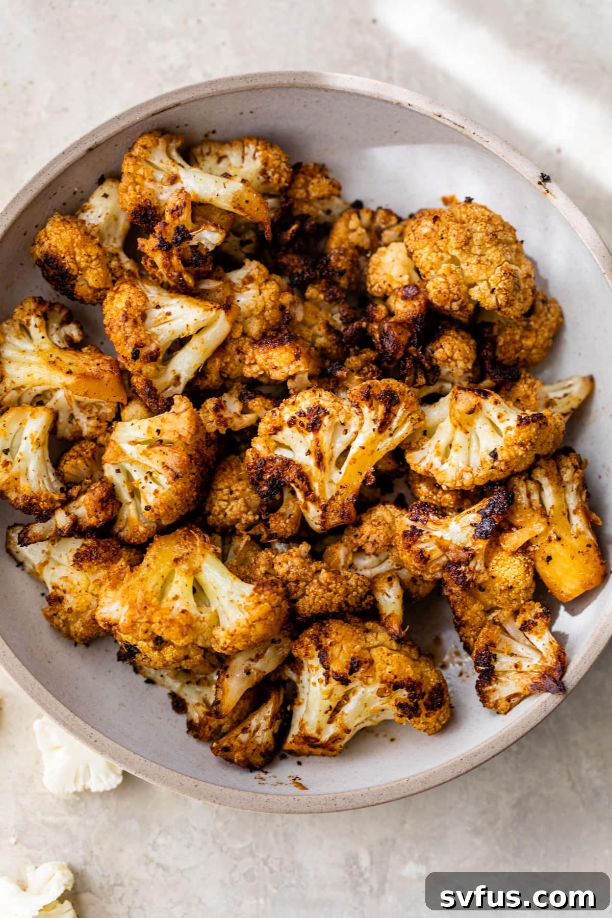 Close-up of perfectly charred and seasoned grilled cauliflower florets on a plate