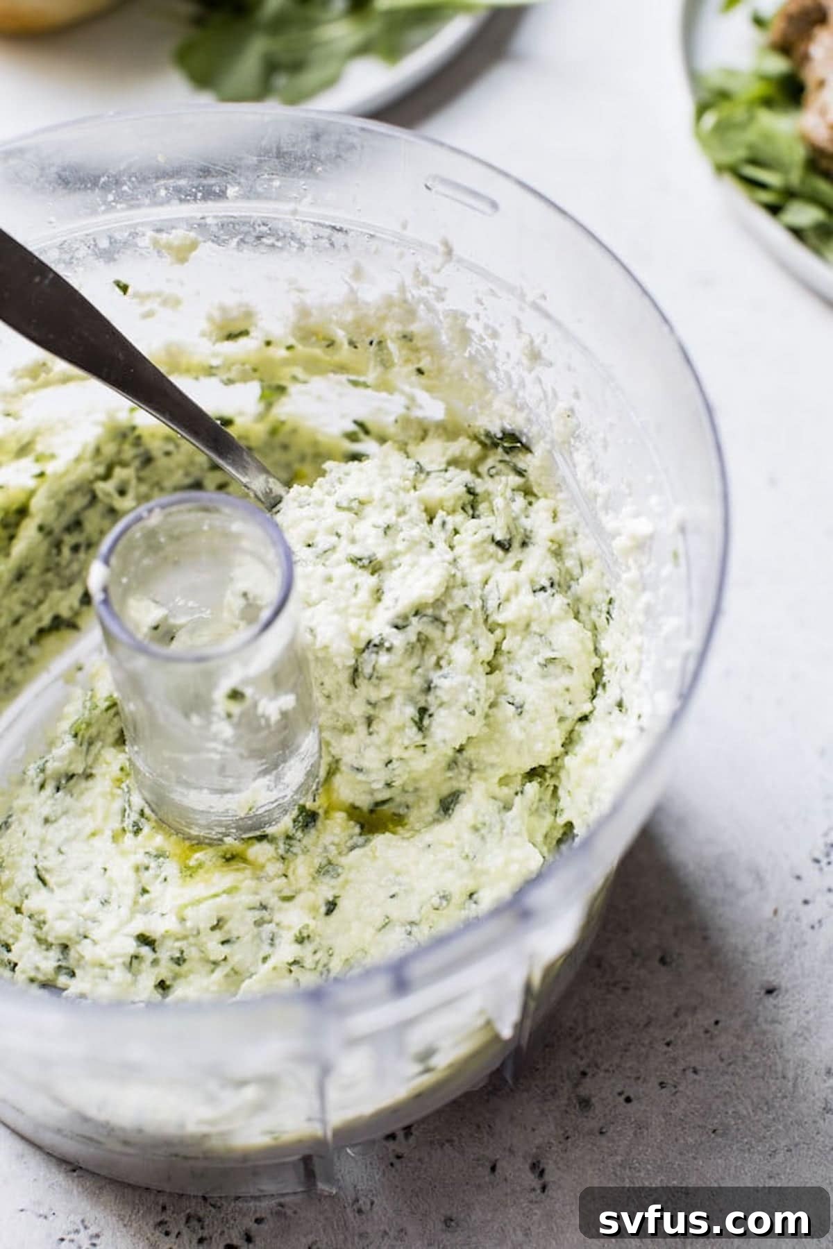 Creamy whipped feta mixture in a food processor