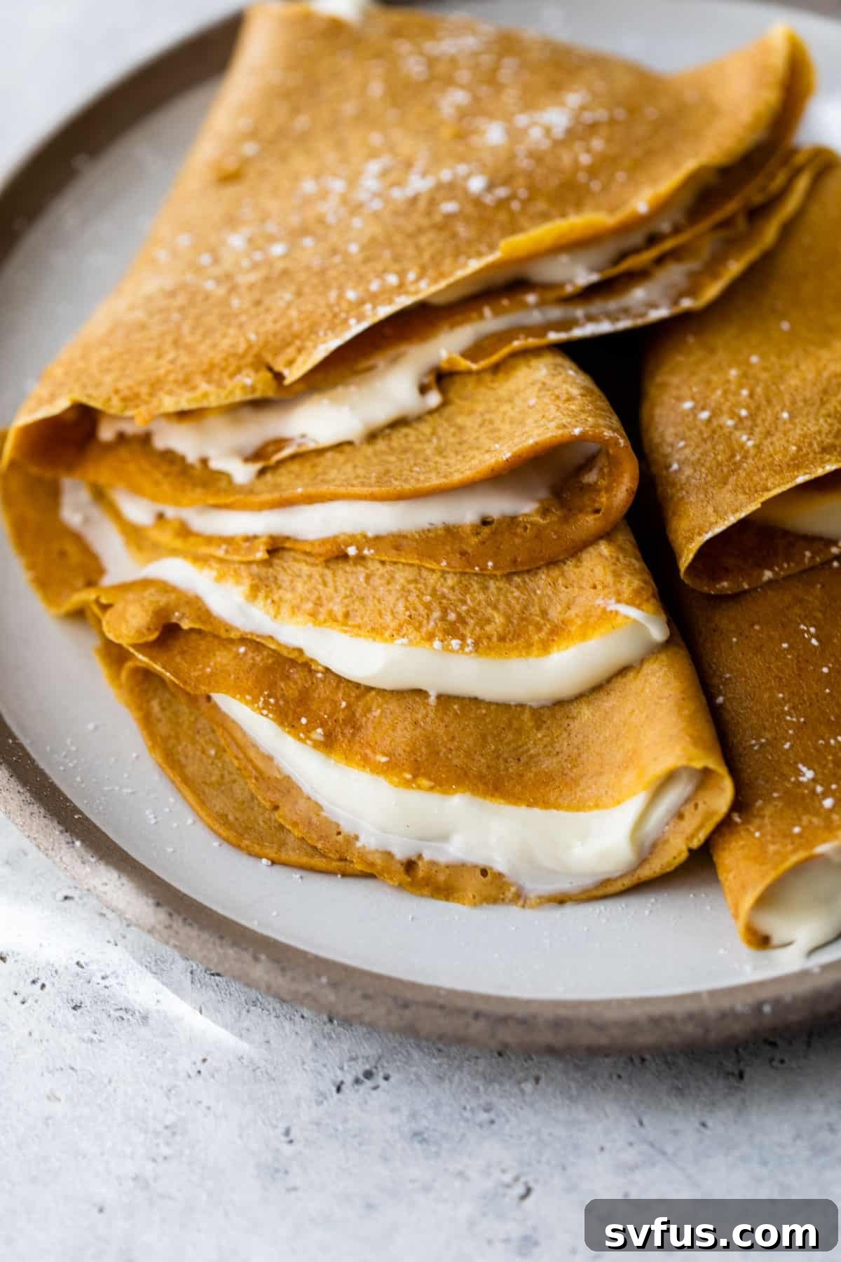 A close-up shot of freshly prepared pumpkin crepes, beautifully stacked and ready for serving.