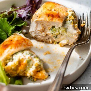 stuffed chicken breast on a plate with a fork
