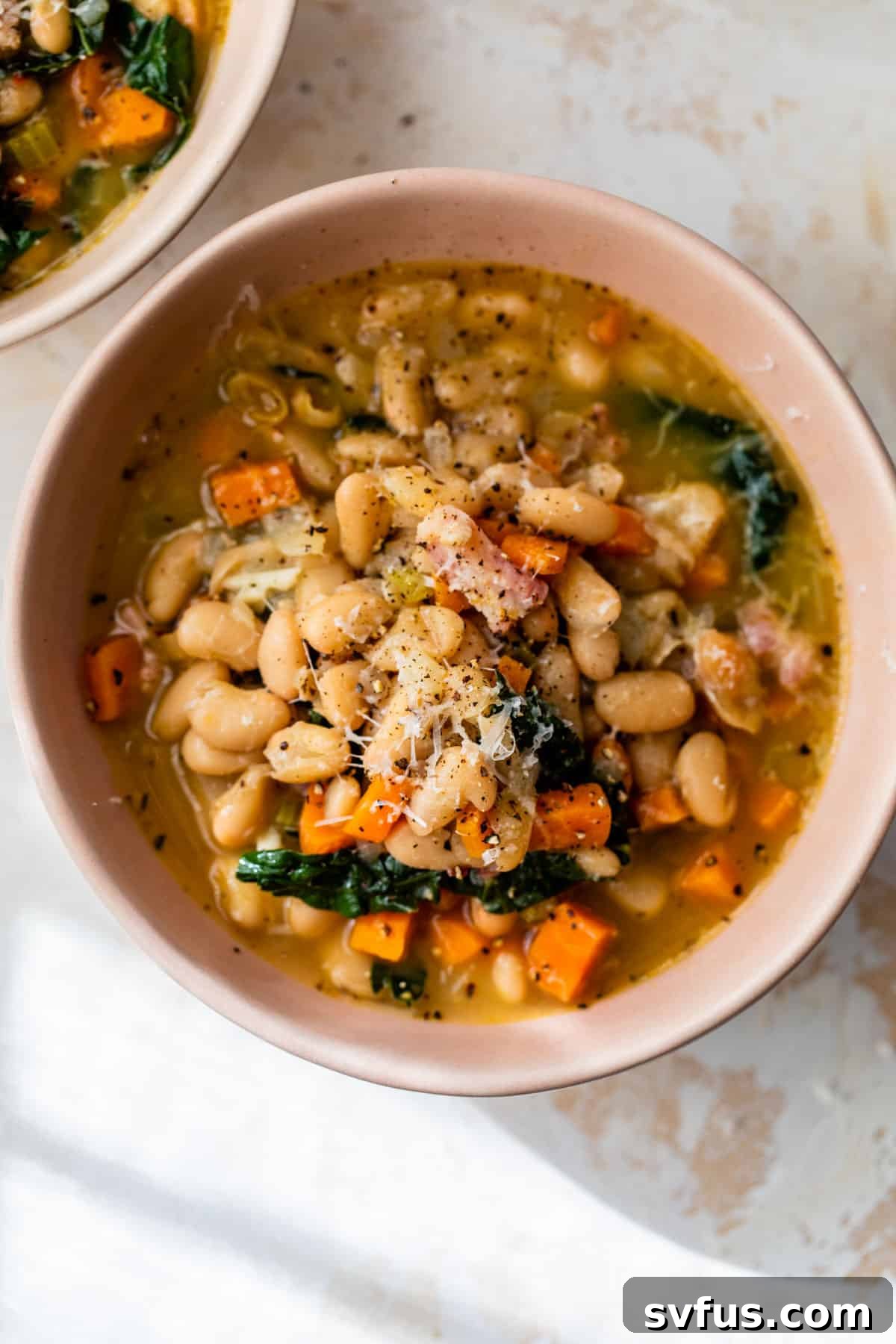 A close-up shot of creamy white bean soup in a rustic bowl, garnished and ready to be served.