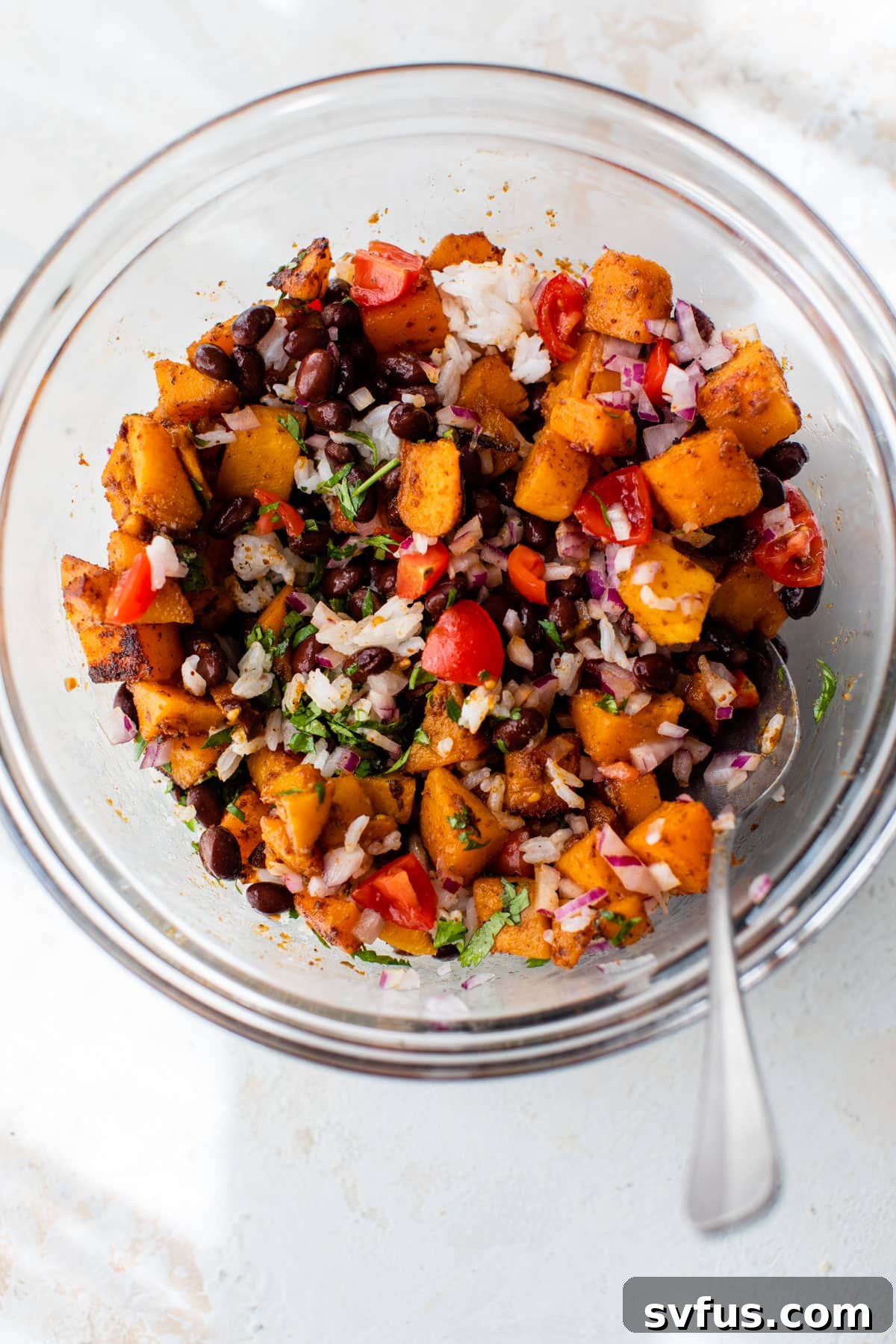 enchilada filling in a glass bowl with a spoon