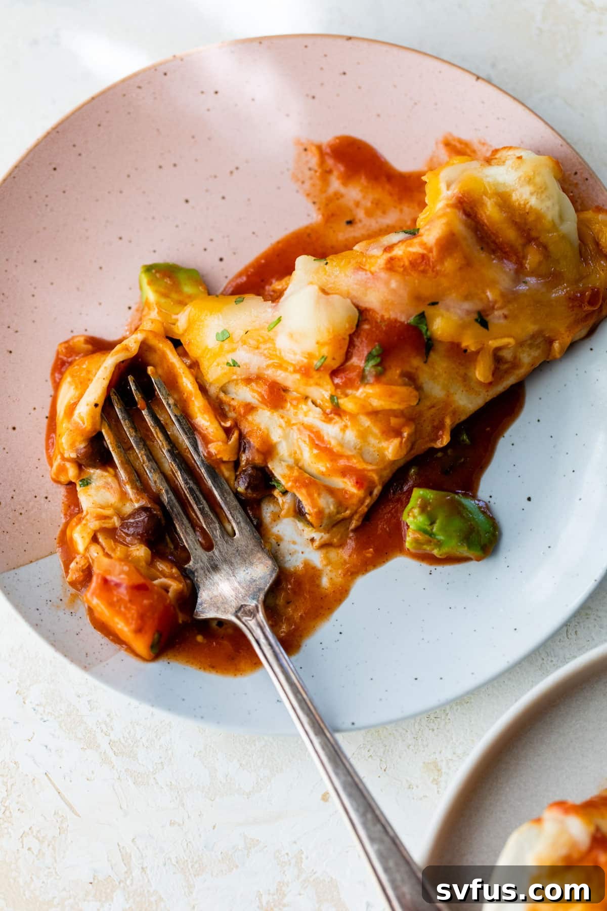 butternut squash enchilada on a plate with a fork