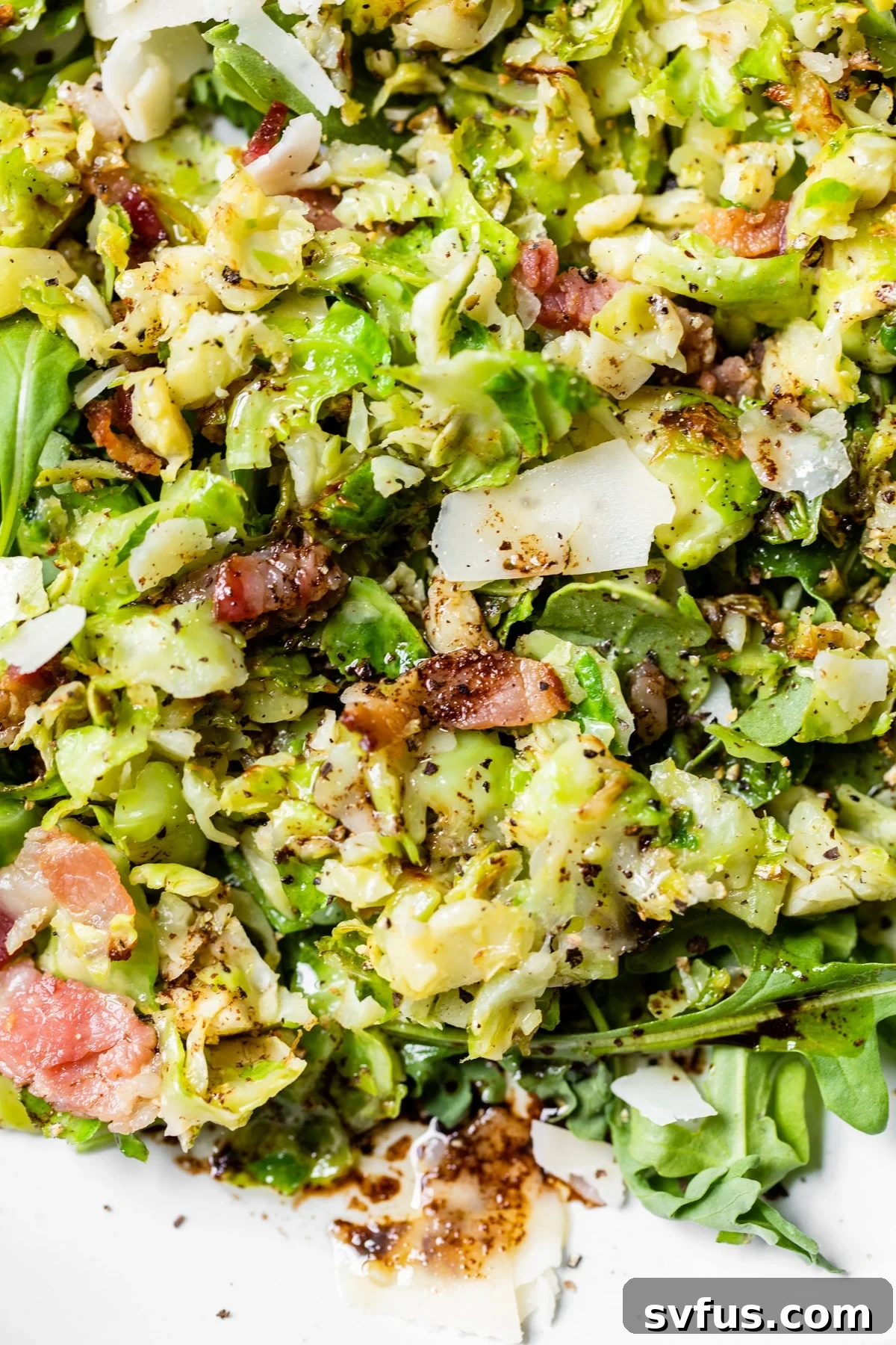 A close-up shot of a serving of Brussels sprouts salad, highlighting the texture and dressing