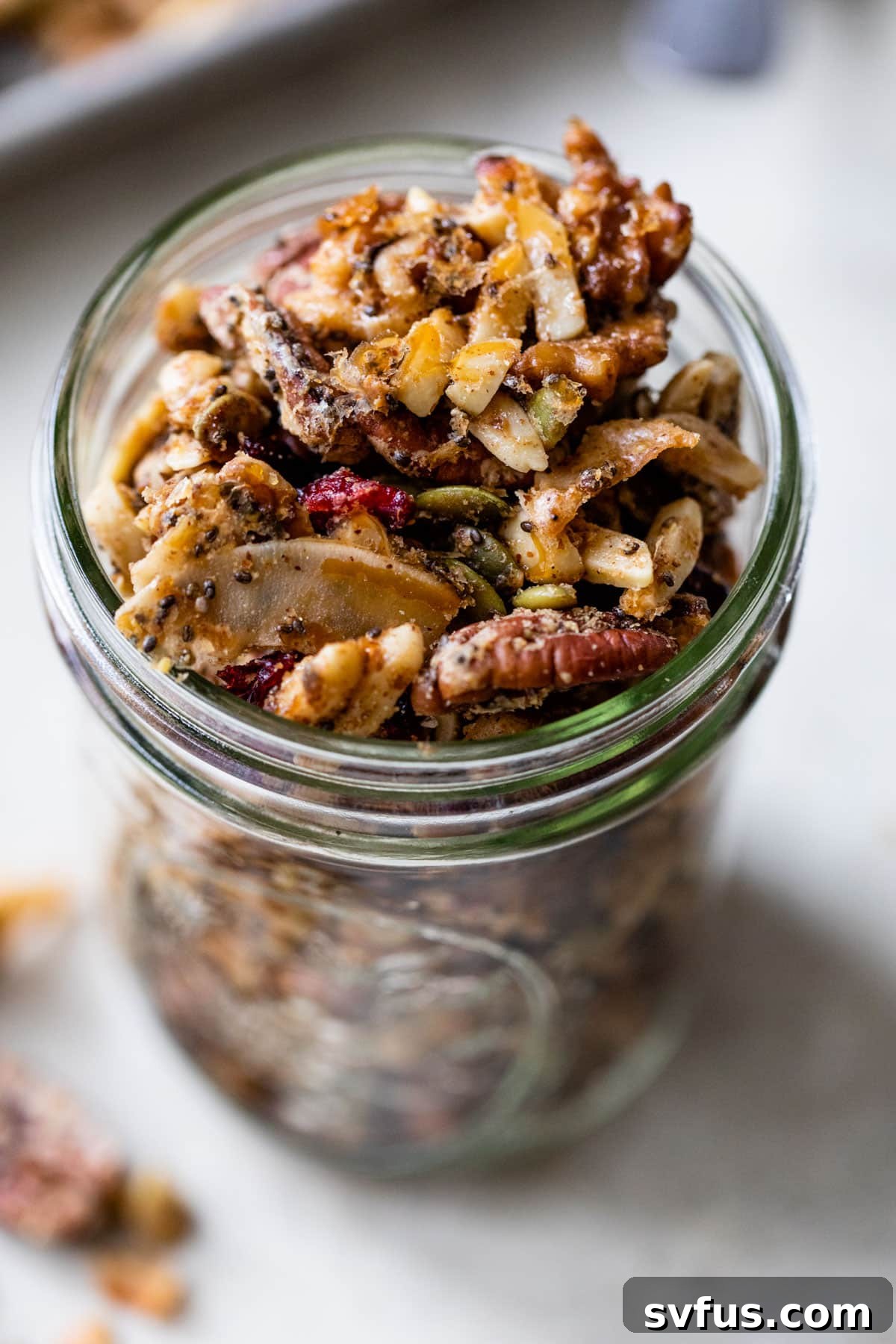 glass jar filled with grain-free granola, ready for storage or serving