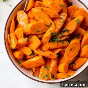 instant pot carrots inside a bowl with a fork and fresh parsley on top