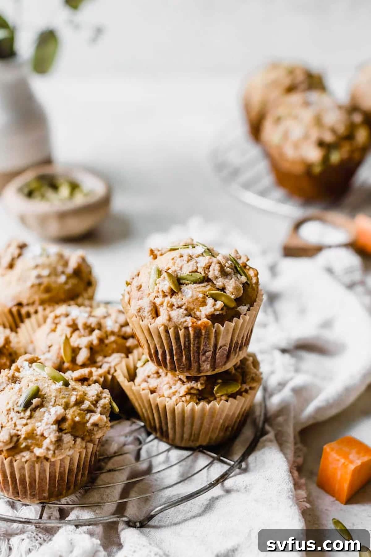 A stack of freshly baked healthy sweet potato muffins, with a prominent crumb topping, ready to be enjoyed as a wholesome treat.