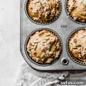 Healthy Sweet Potato Muffins in a baking tin, topped with a delicious crumb