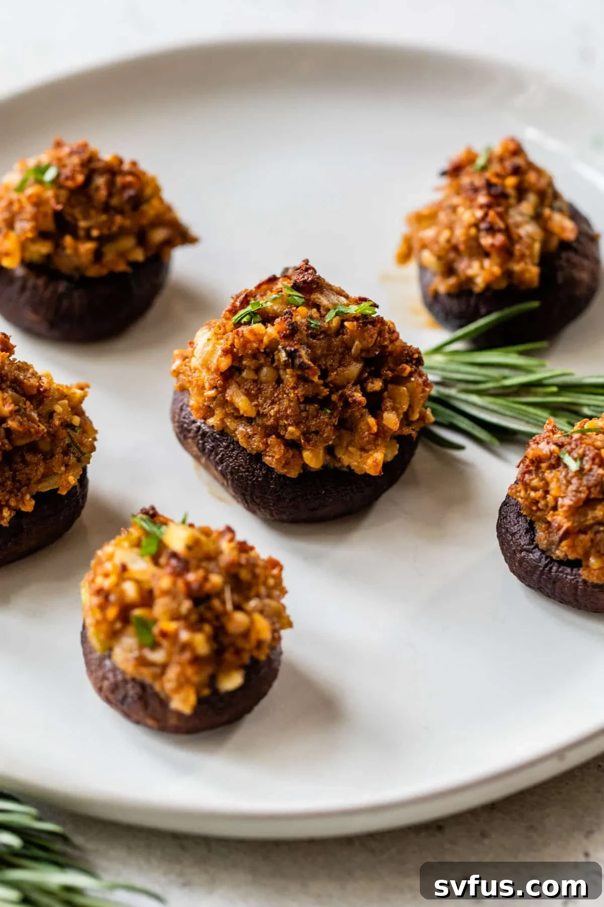 Close-up overview of perfectly baked vegan stuffed mushrooms, garnished with fresh parsley.