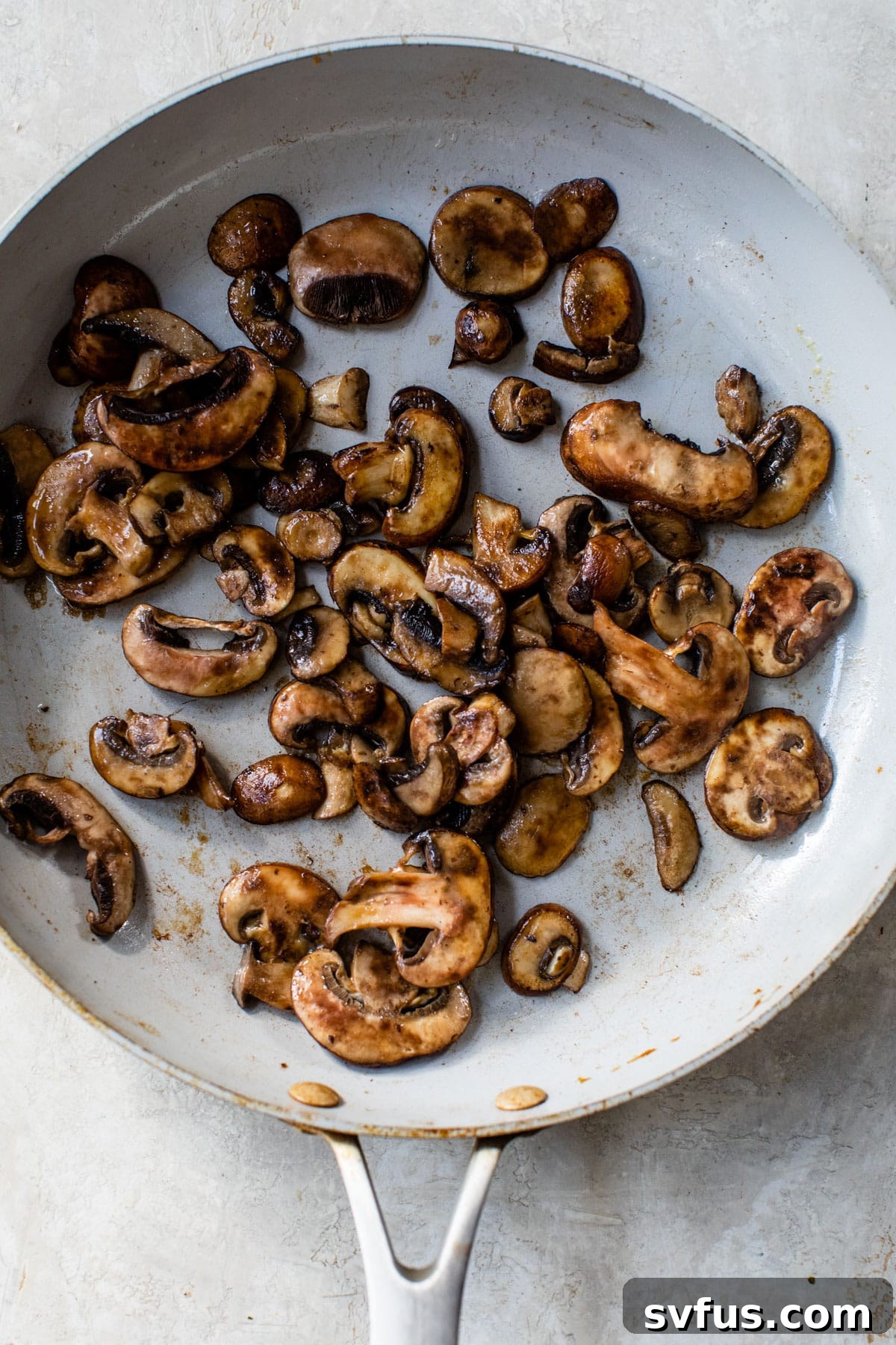 mushrooms cooking in a skillet