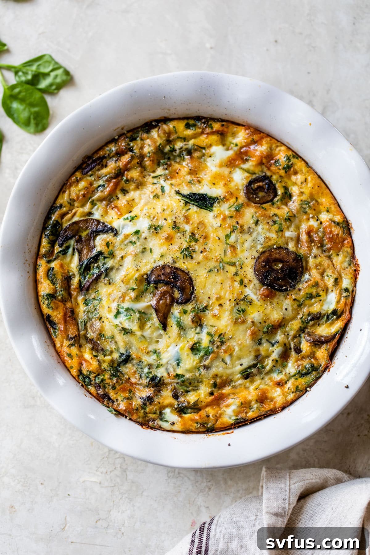 overview of the spinach mushroom quiche in a pie pan