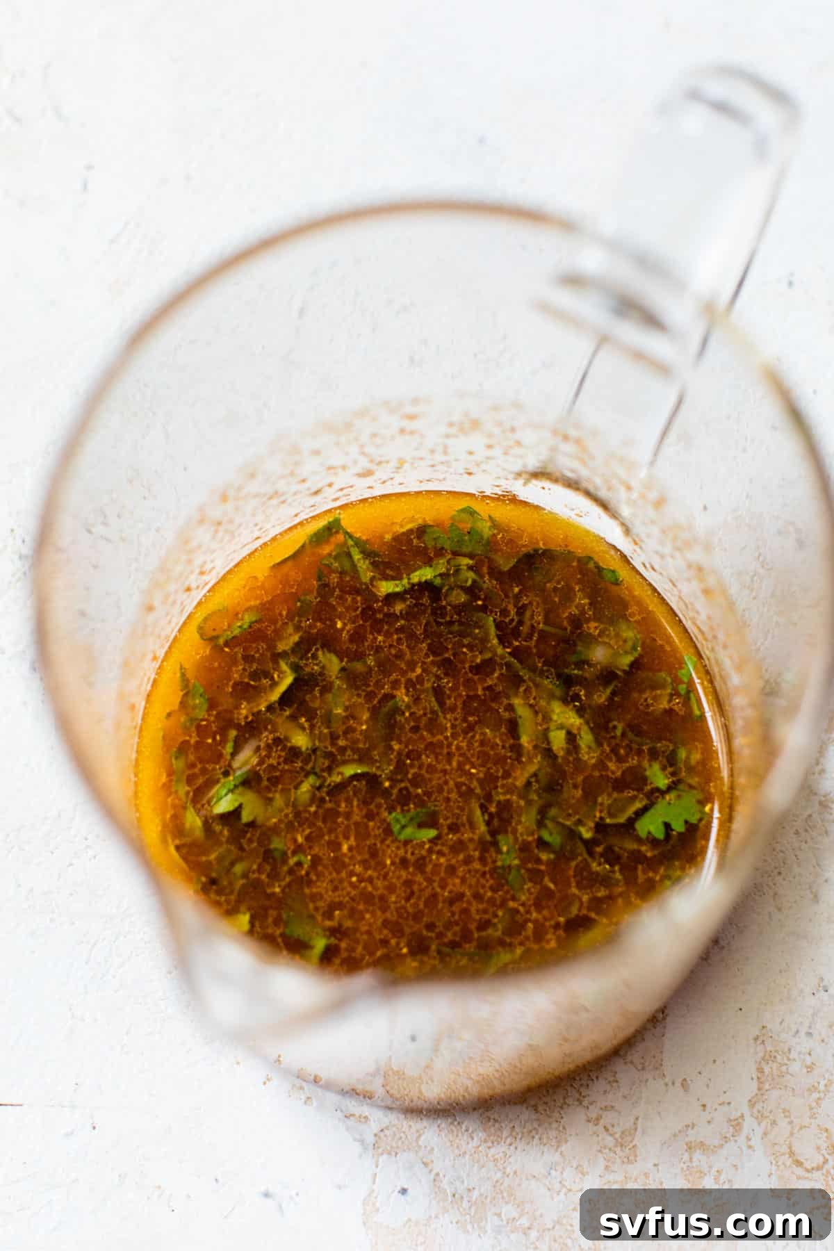 homemade vinaigrette in a glass measuring cup