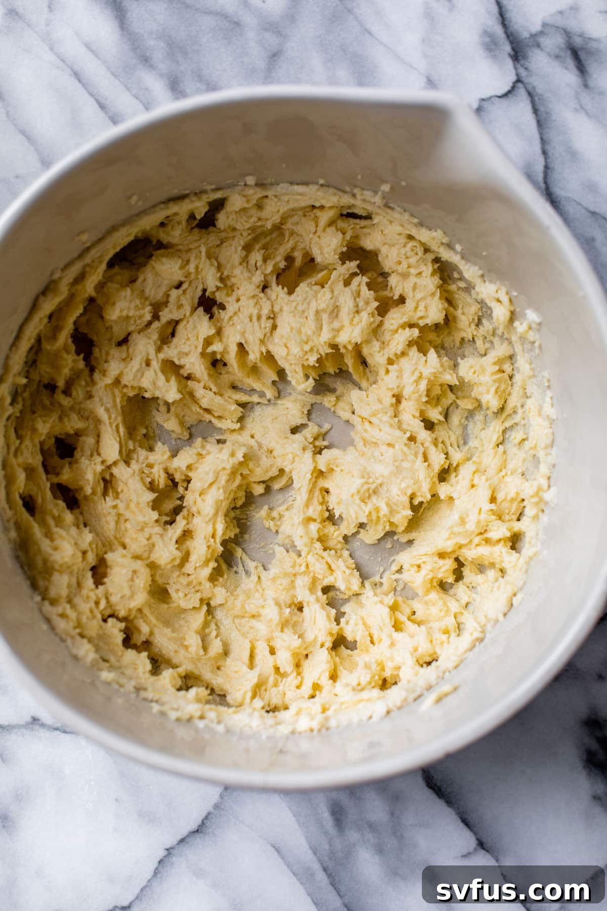 Creamed butter and sugar in a large bowl, ready for dry ingredients.