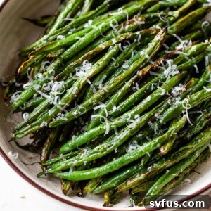air fryer green beans in a bowl with grated cheese on top