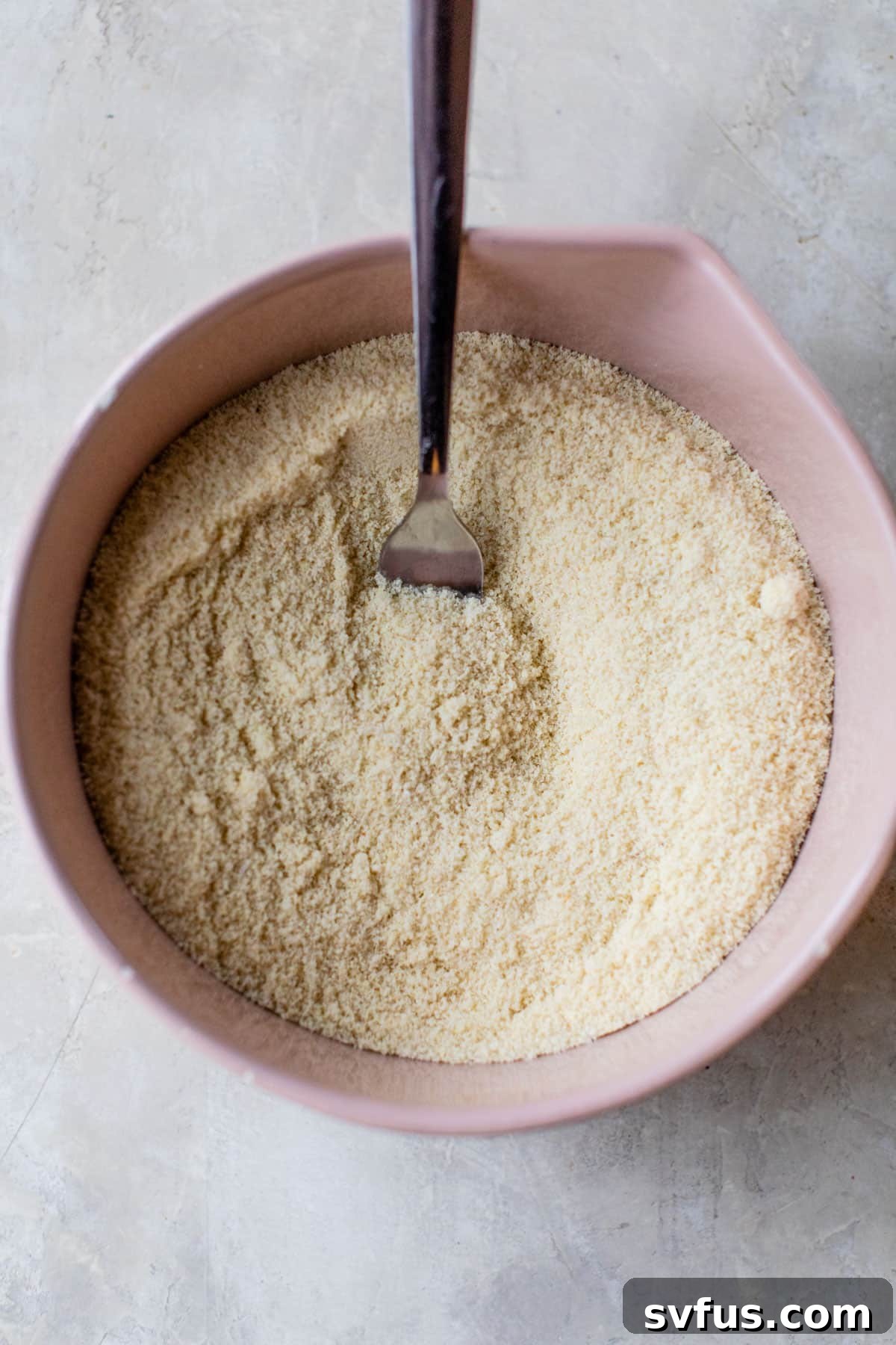 dry ingredients mixed together in a bowl with a fork