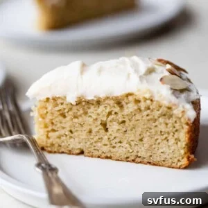 a side view slice of almond flour vanilla cake on a plate with a fork
