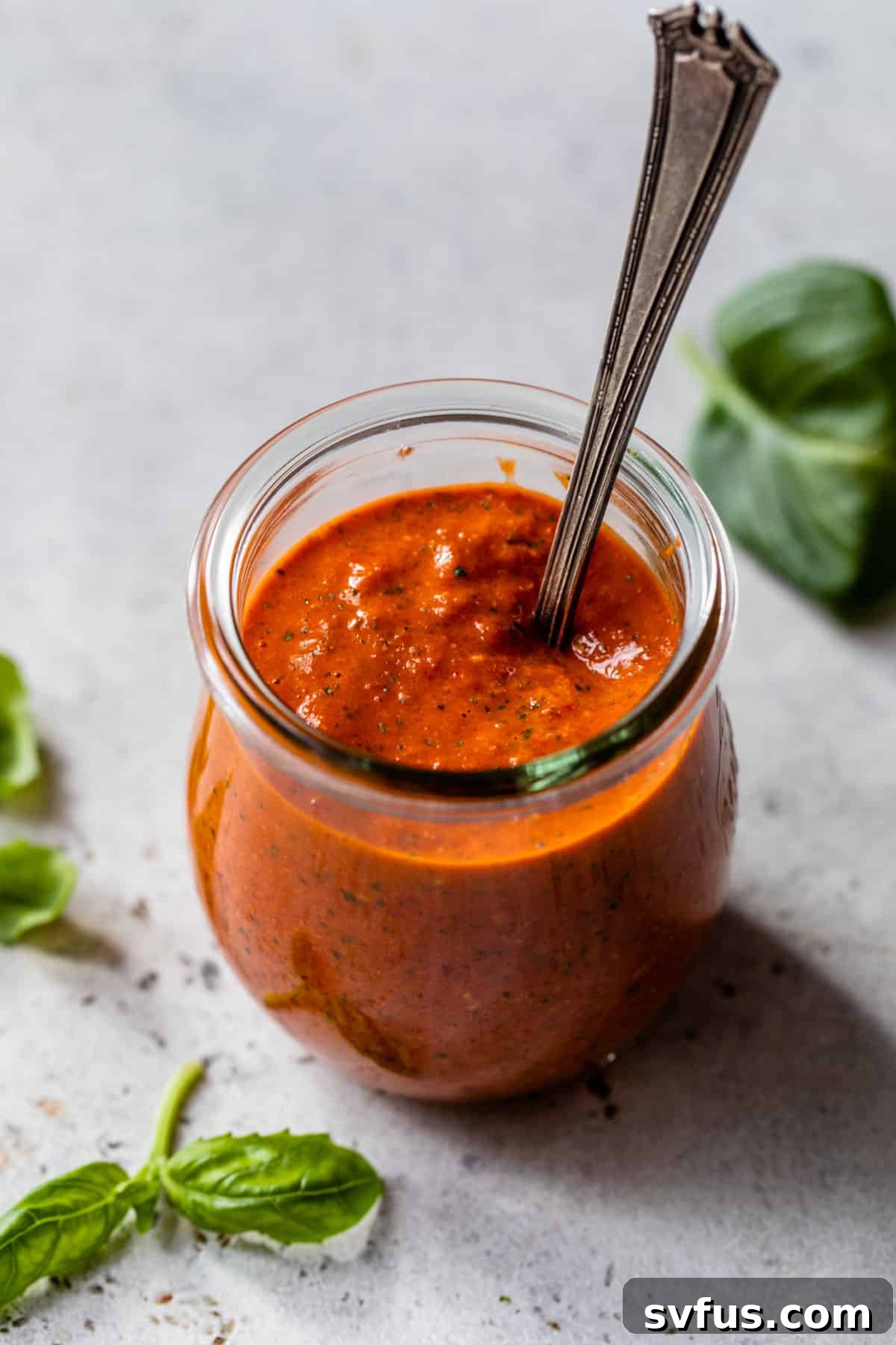 red pepper pesto in a jar with a spoon