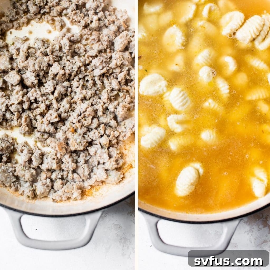 Sausage and gnocchi cooking in a large skillet with a creamy sauce.