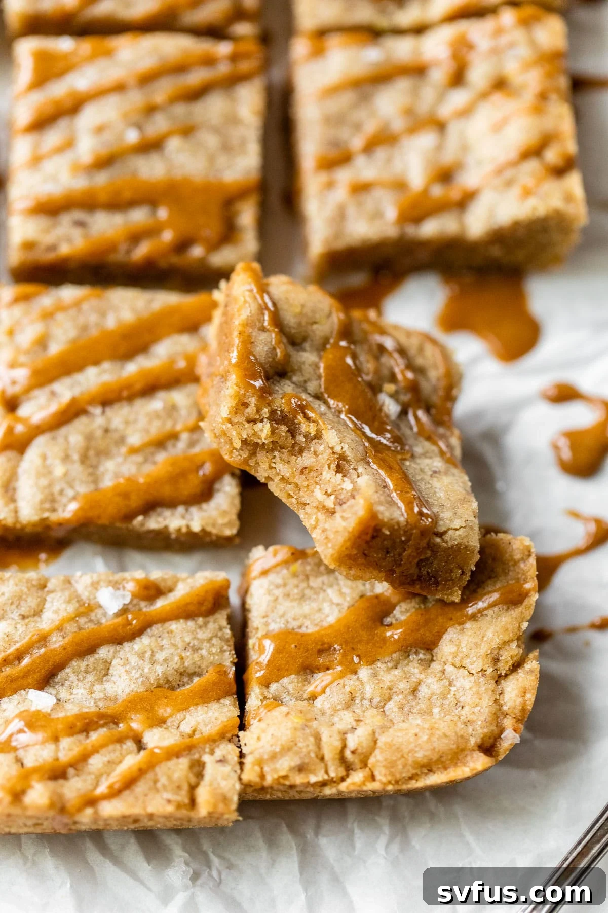 A vegan dirty chai blondie with a bite taken out, showing its soft, chewy interior.