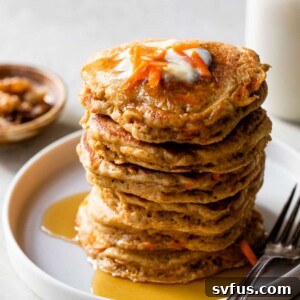 a stack of carrot pancakes on a plate with a fork