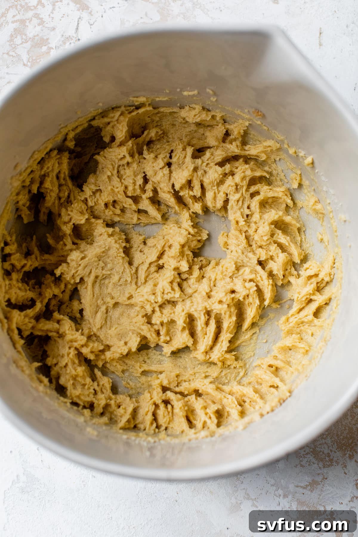 Creamed butter and sugars with egg and peppermint extract mixed together in a large bowl