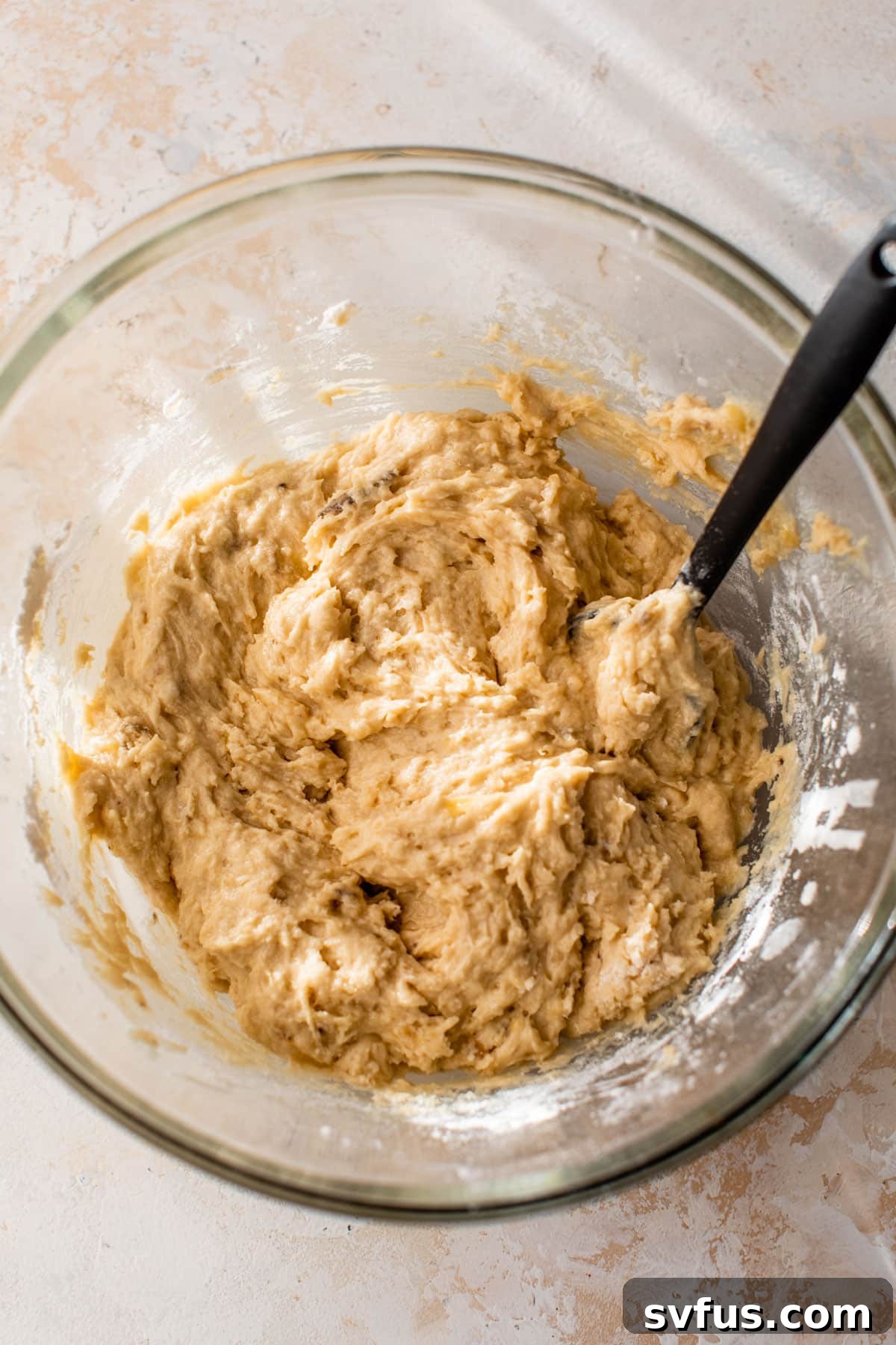 coffee cake batter in a glass bowl with a spatula