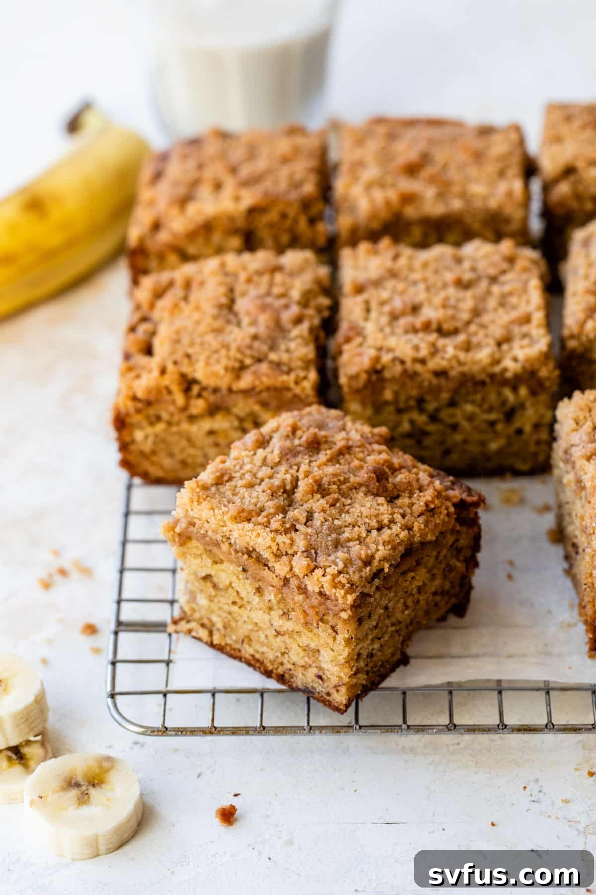 sliced banana coffee cake on a wire rack