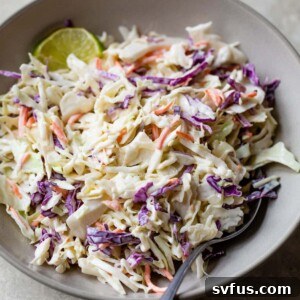 homemade coleslaw in a bowl with a fork