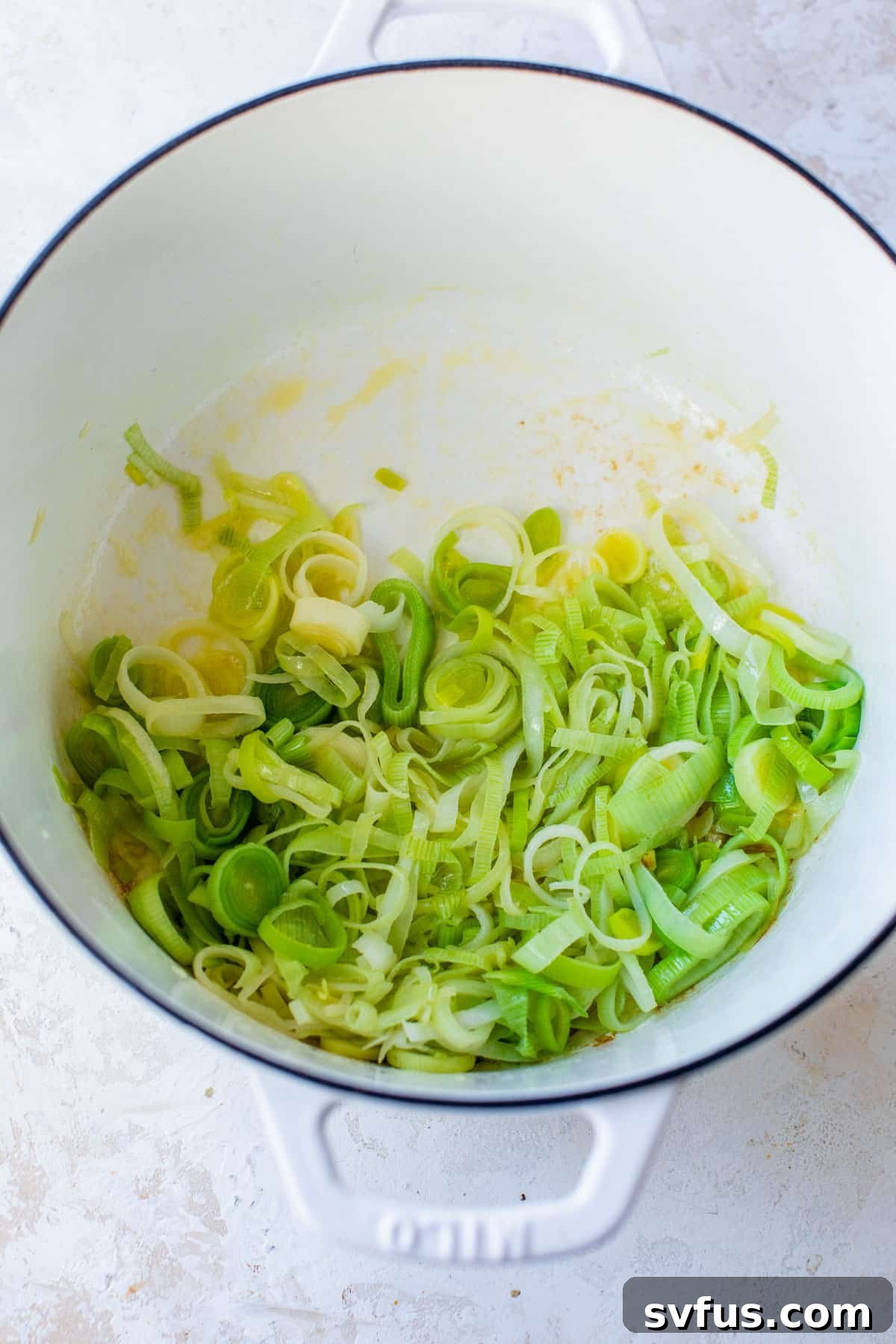leeks sautéing in a dutch oven