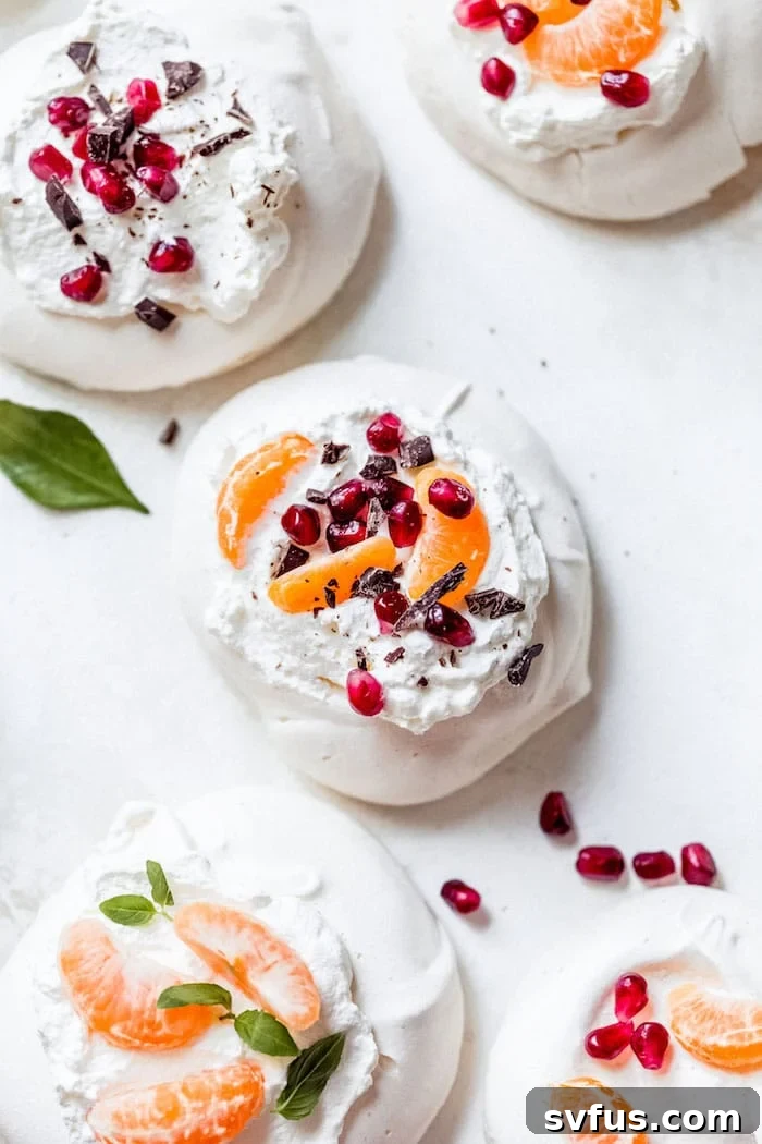 Mini Pavlovas with whipped cream and fresh fruit toppings