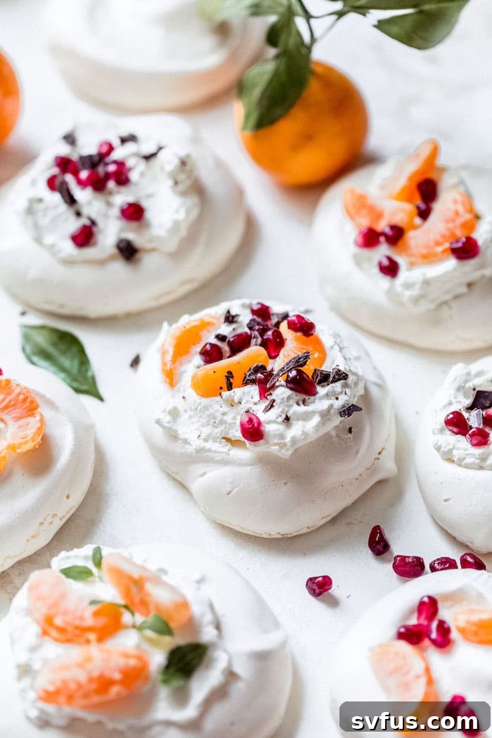 Mini Pavlovas with whipped cream and various festive toppings