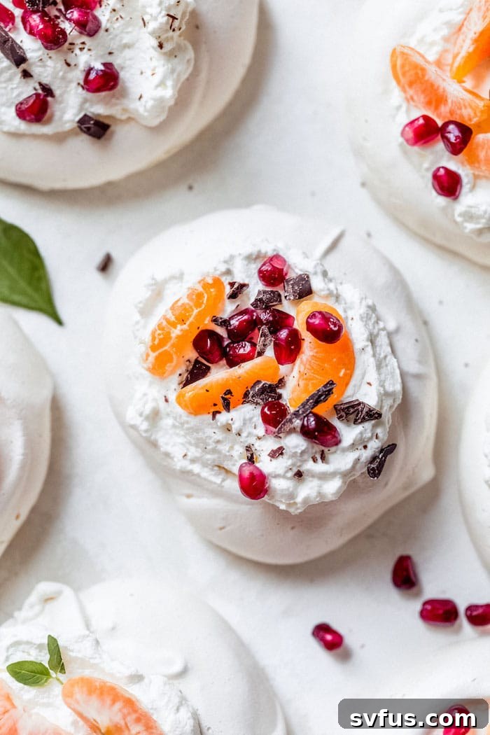 Close-up of Mini Pavlovas topped with fresh fruit and chocolate