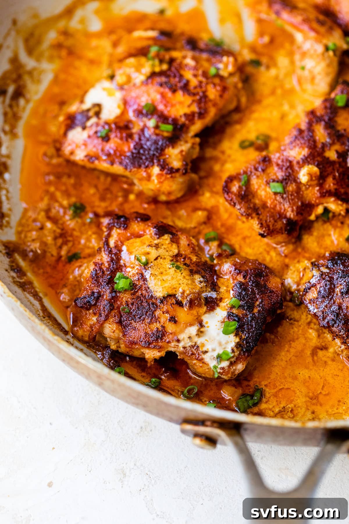 Cooked paprika chicken simmering in a creamy sauce within a large skillet, ready to be served.