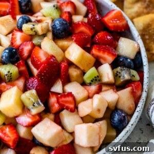 close-up of fruit salsa in a bowl with graham crackers and cinnamon pita chips off to the side
