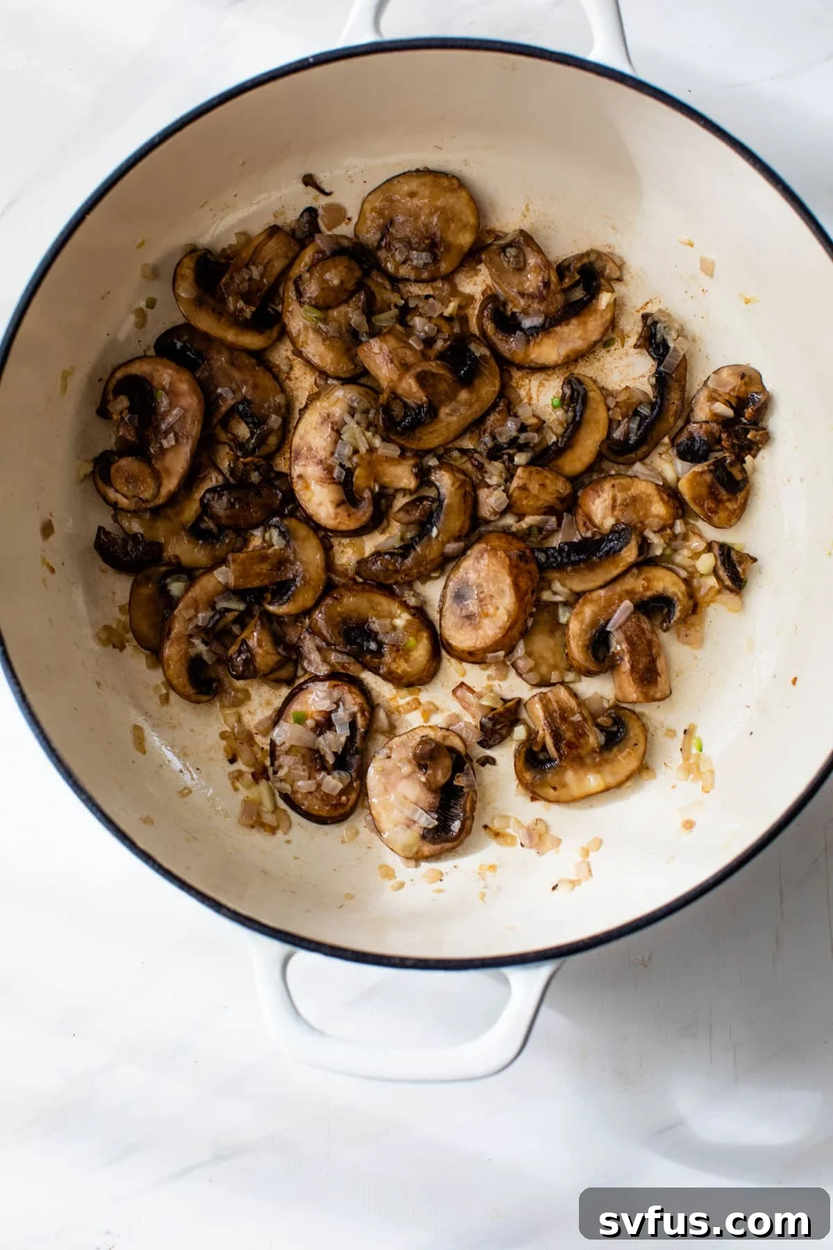 Sautéing mushrooms and shallots in a Dutch oven for shrimp risotto