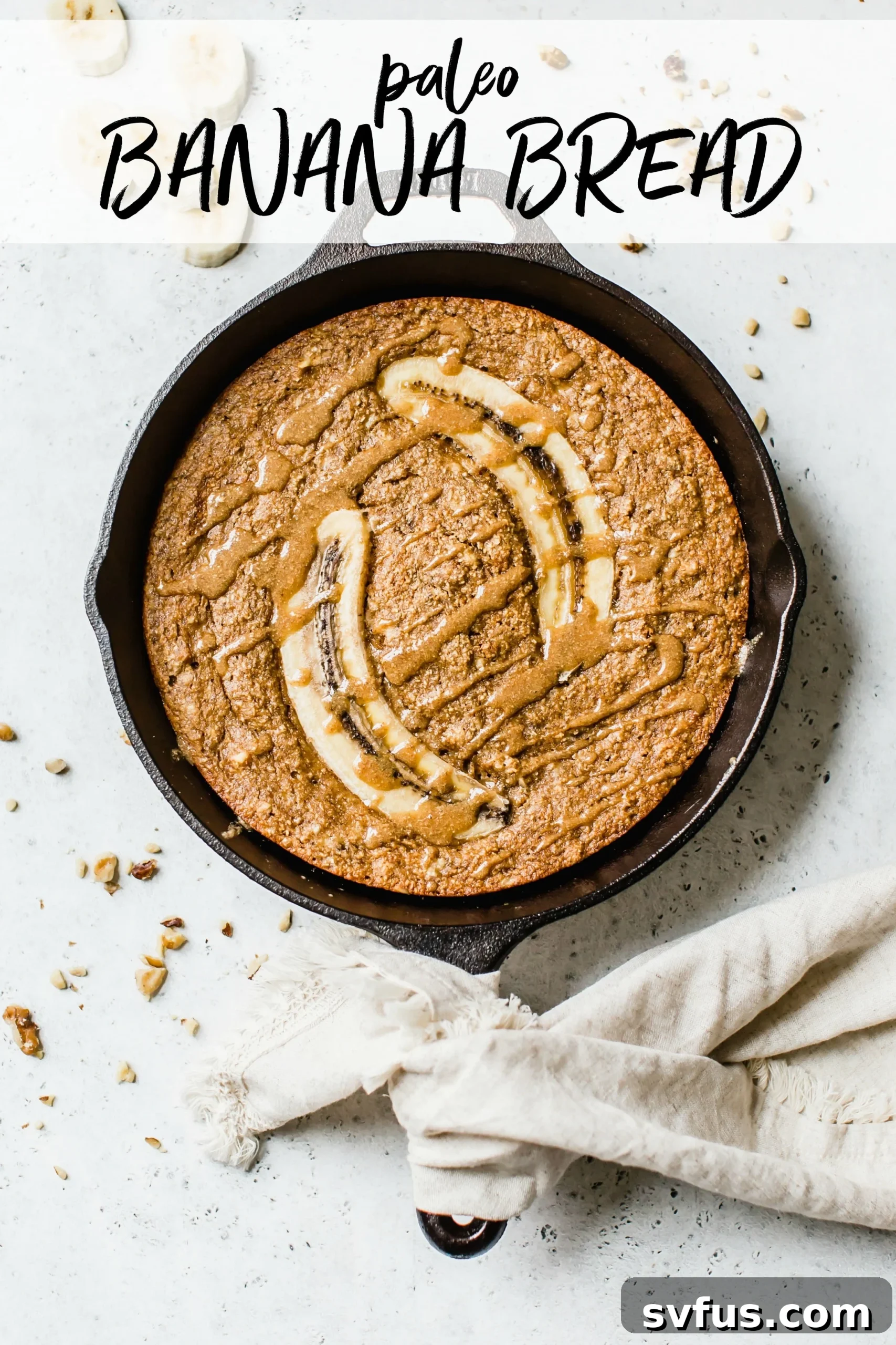 Delicious Paleo Skillet Banana Bread drizzled with almond butter, fresh from the oven.