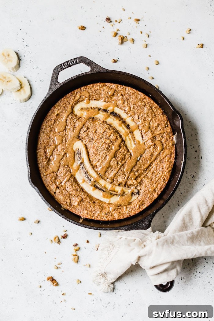 Mixing the wet and dry ingredients for Paleo Skillet Banana Bread in a large bowl.