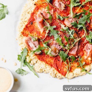Whole30 pizza recipe made with cauliflower crust and your choice of toppings! #whole30 | thealmondeater.com