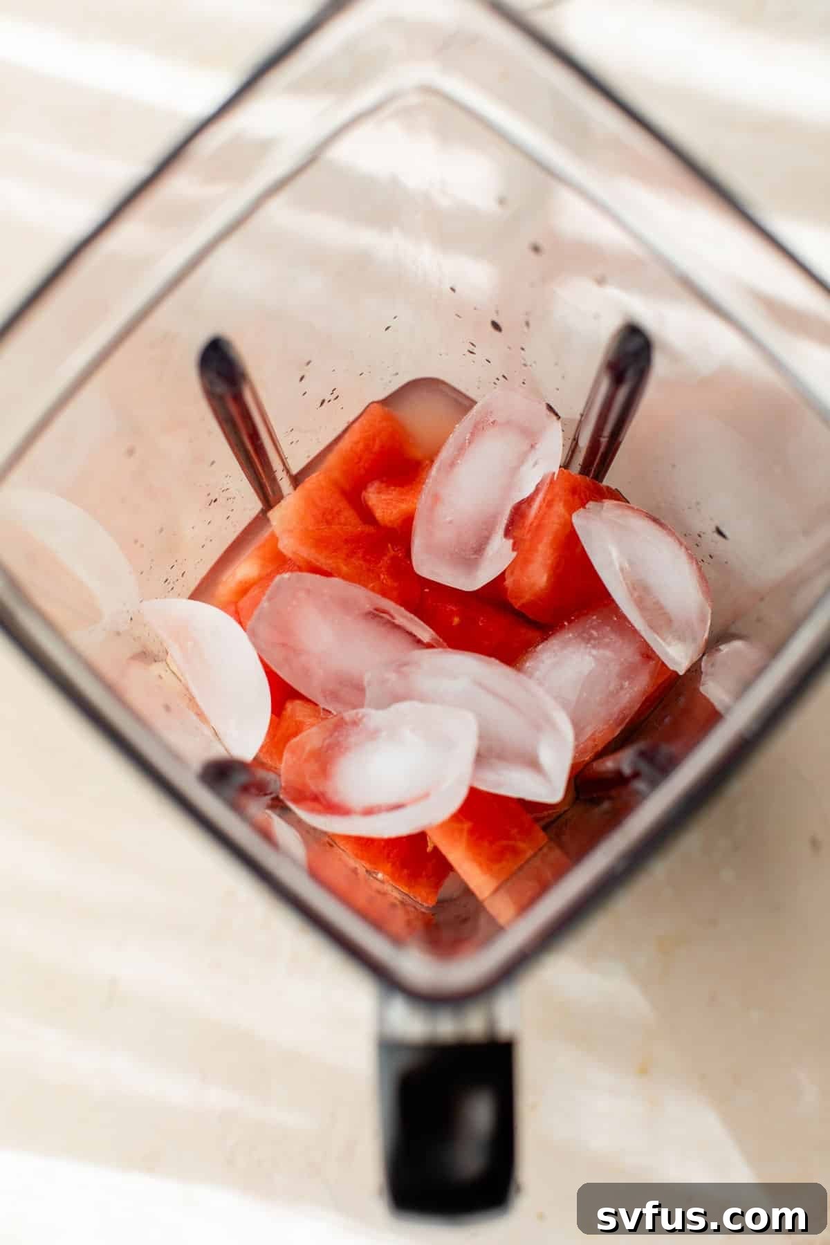 ice and other ingredients added to the blender with watermelon