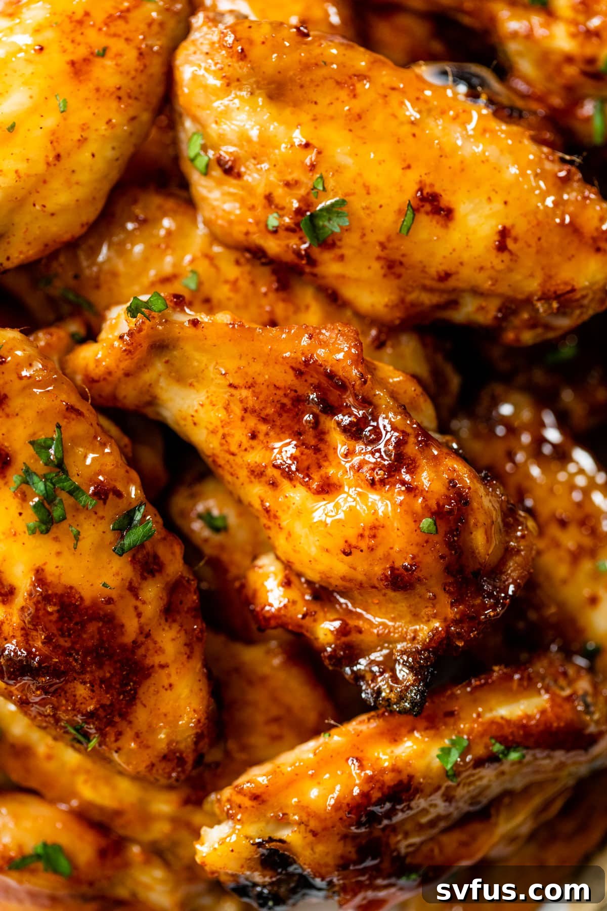 A closer view of the perfectly glazed and stacked hot honey chicken wings, invitingly delicious.