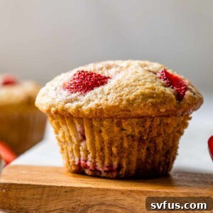 Side view of a strawberry muffins on a cutting board