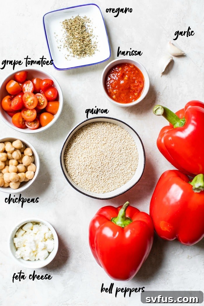 A collection of fresh ingredients for quinoa stuffed peppers, including bell peppers, quinoa, feta, and harissa, laid out attractively in bowls.