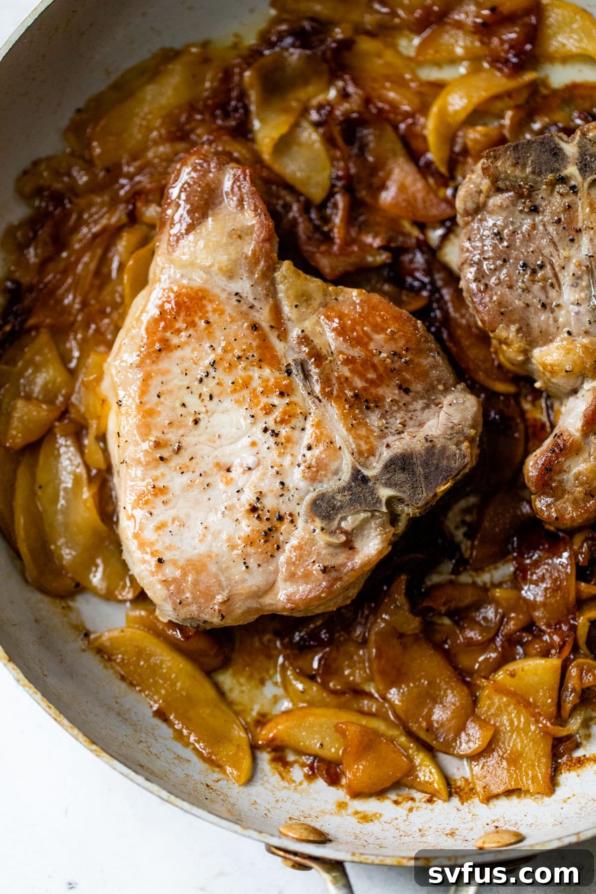 close-up of apple pork chops in a skillet