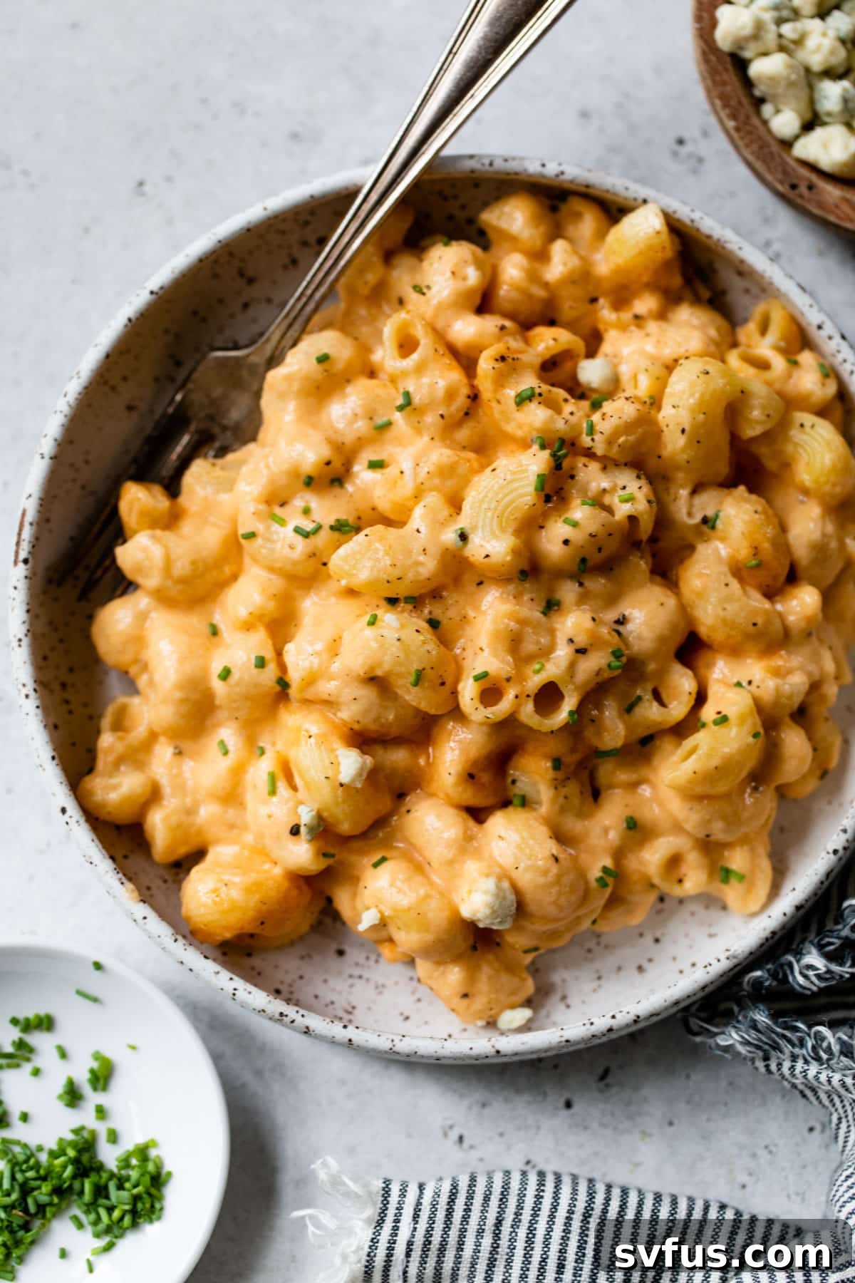 buffalo mac and cheese in a bowl with a fork