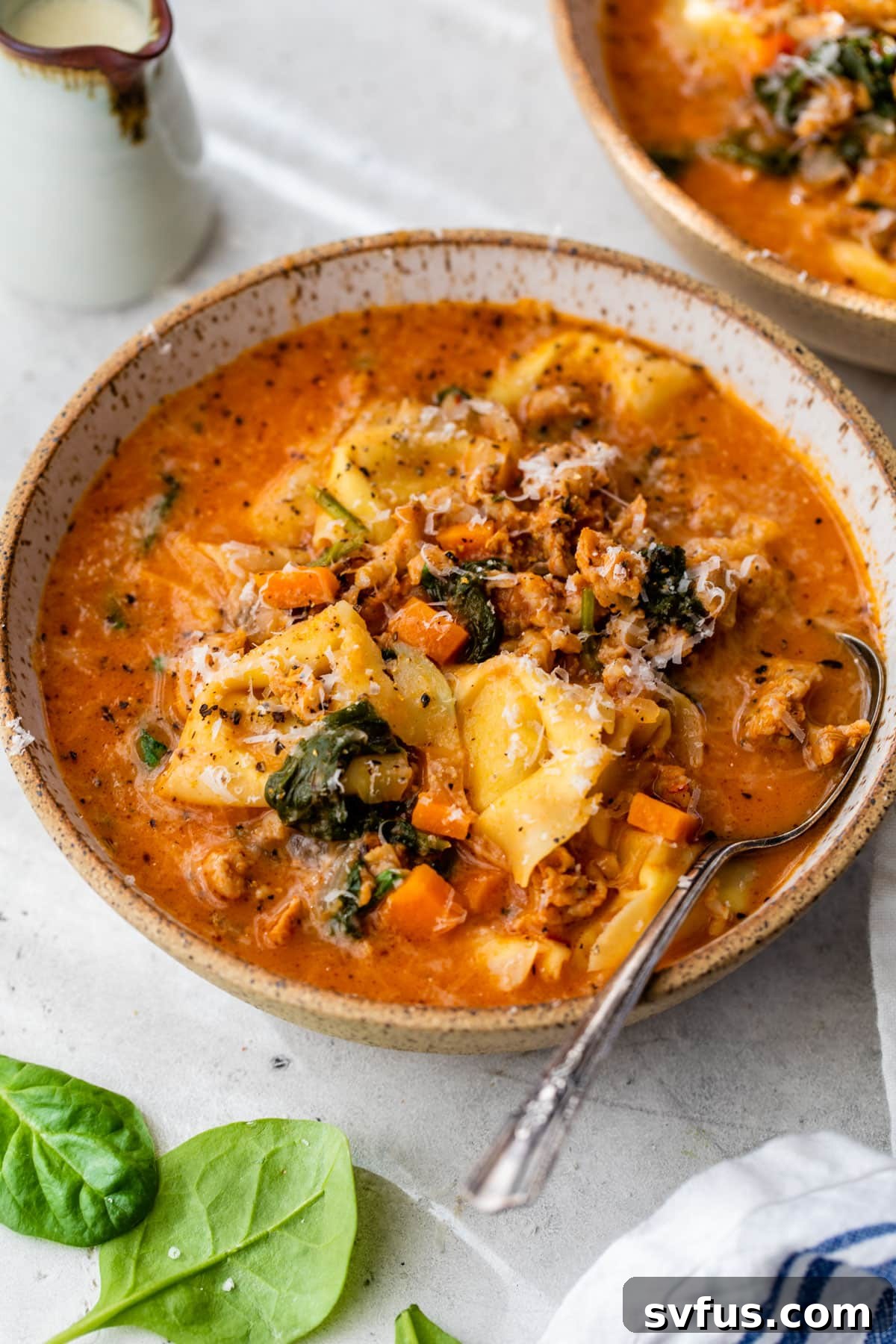 Creamy Sausage Tortellini Soup ready to be served in a bowl.