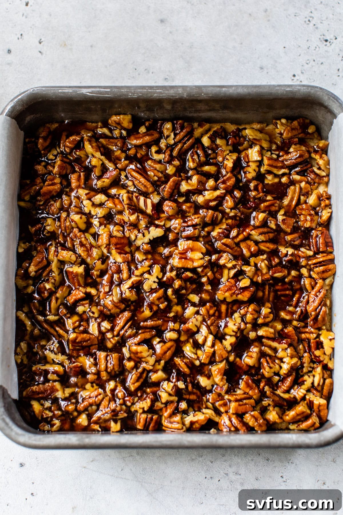 pecan mixture added on top of the cooled crust in a baking dish