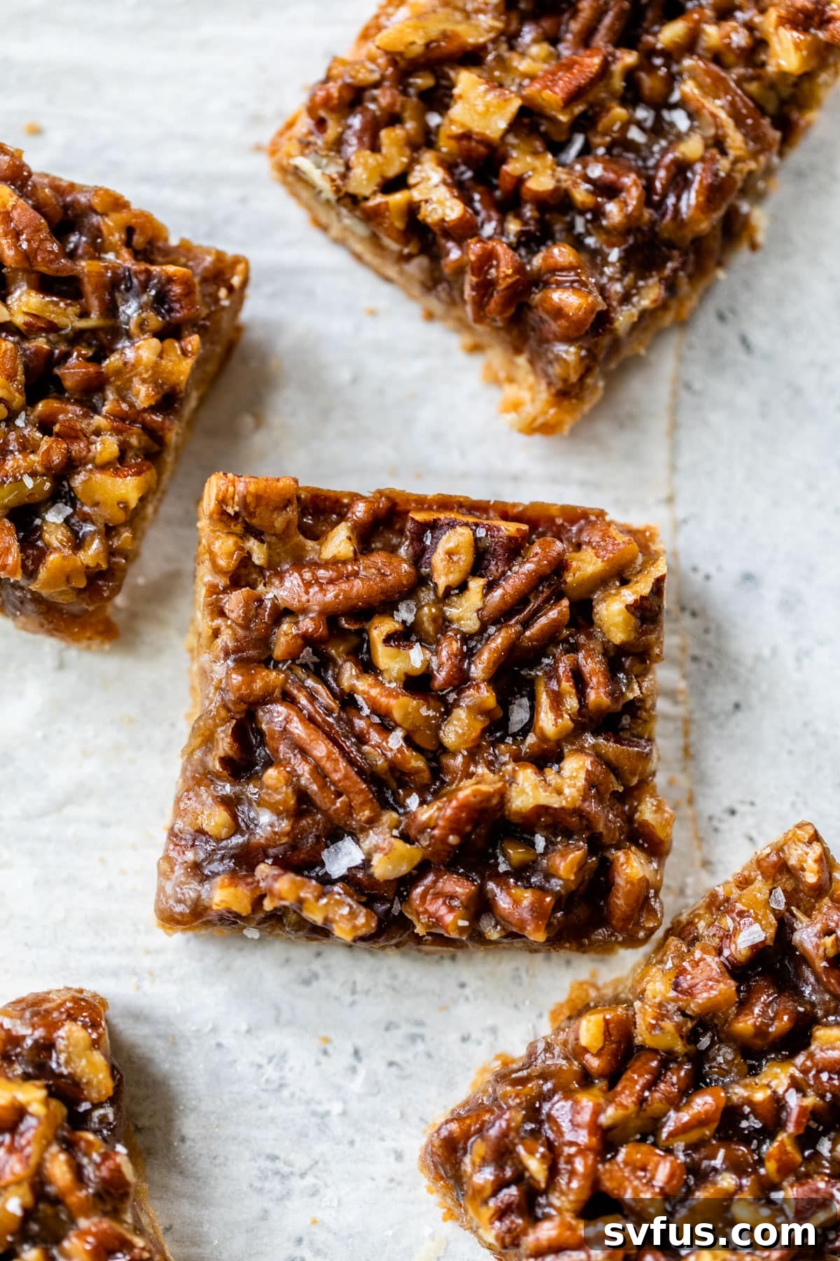 healthy pecan pie bars cut into squares on a table