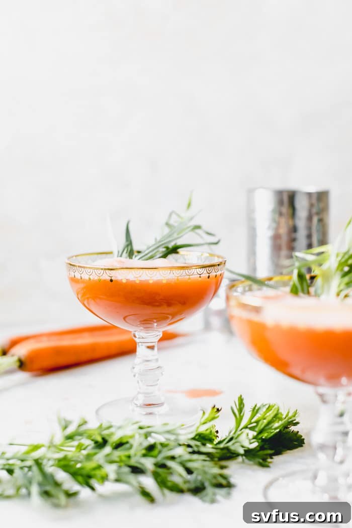 A vibrant Ginger Carrot Juice Cocktail in elegant glassware, garnished for a special touch.