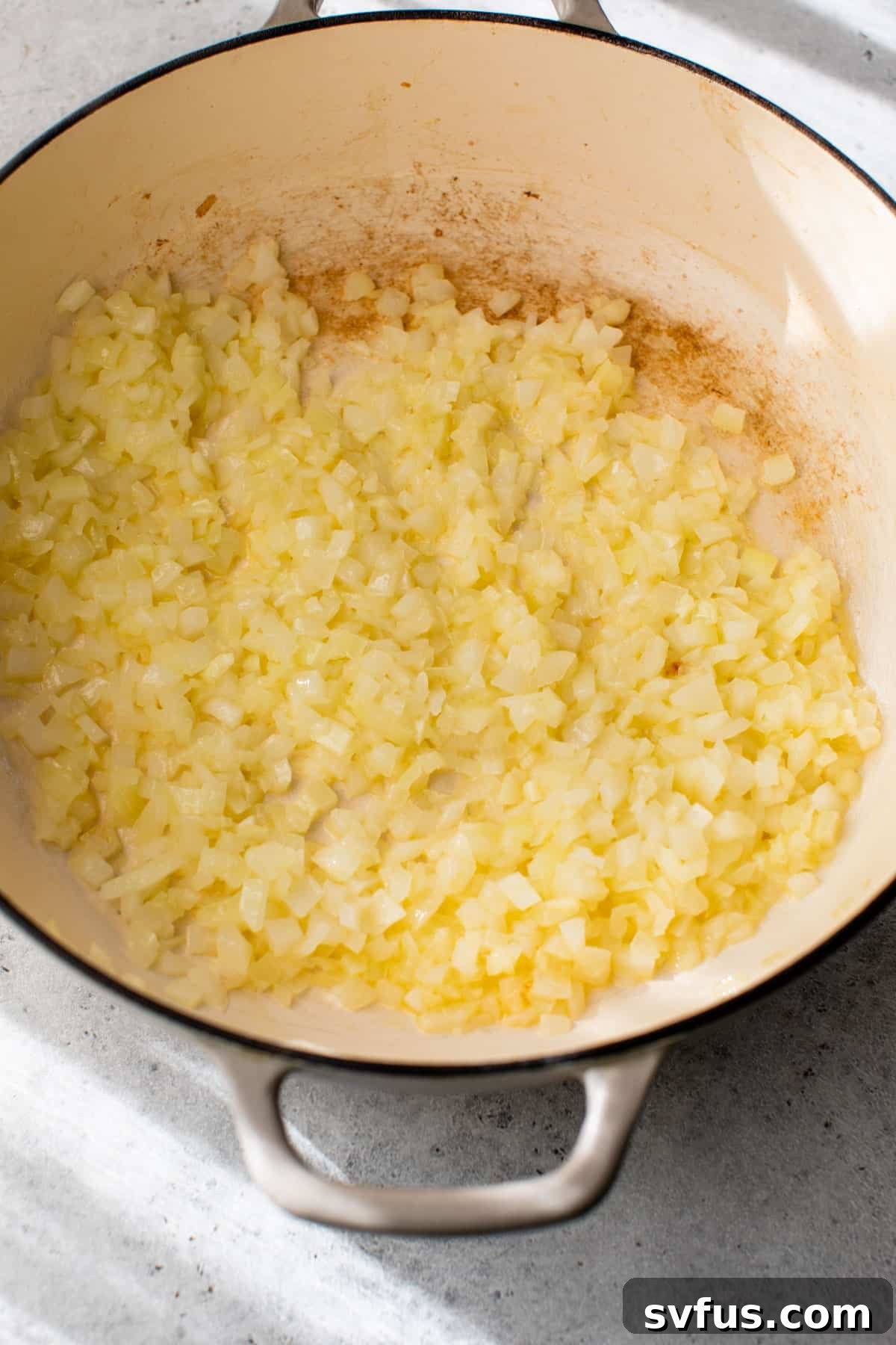 onion sautéing in a dutch oven with butter until translucent